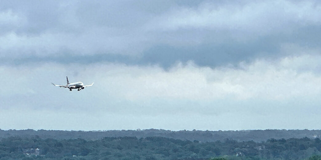 an airplane flying over a forest