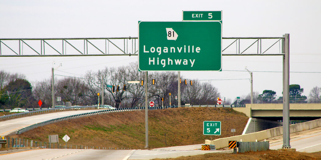 a green sign on a highway