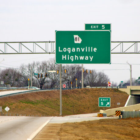 a green sign on a highway