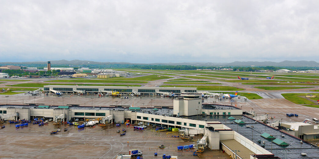 an airport with many vehicles parked on the ground