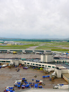 an airport with many vehicles parked on the ground