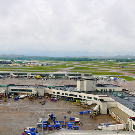 an airport with many vehicles parked on the ground