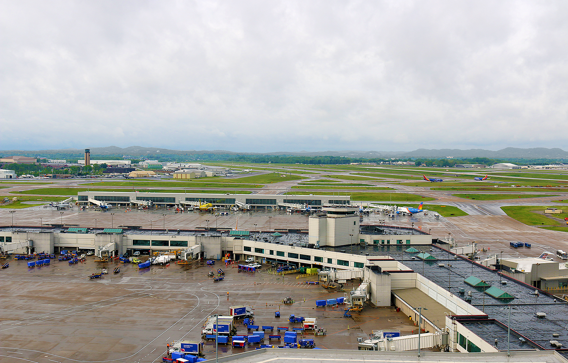 an airport with many vehicles parked on the ground
