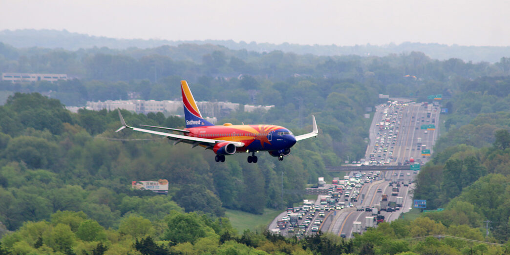 an airplane flying over a highway