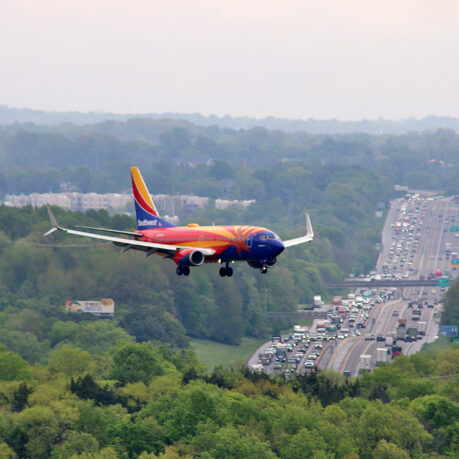 an airplane flying over a highway