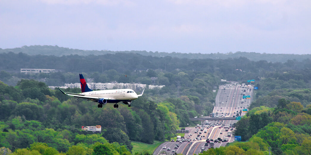 an airplane flying over a highway