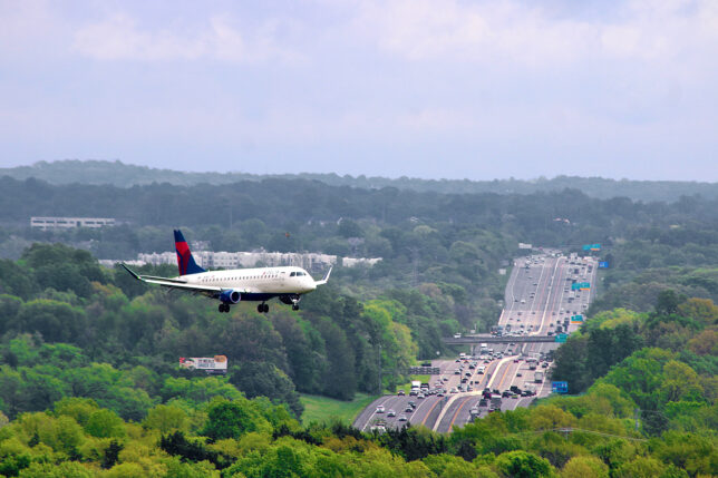 an airplane flying over a highway