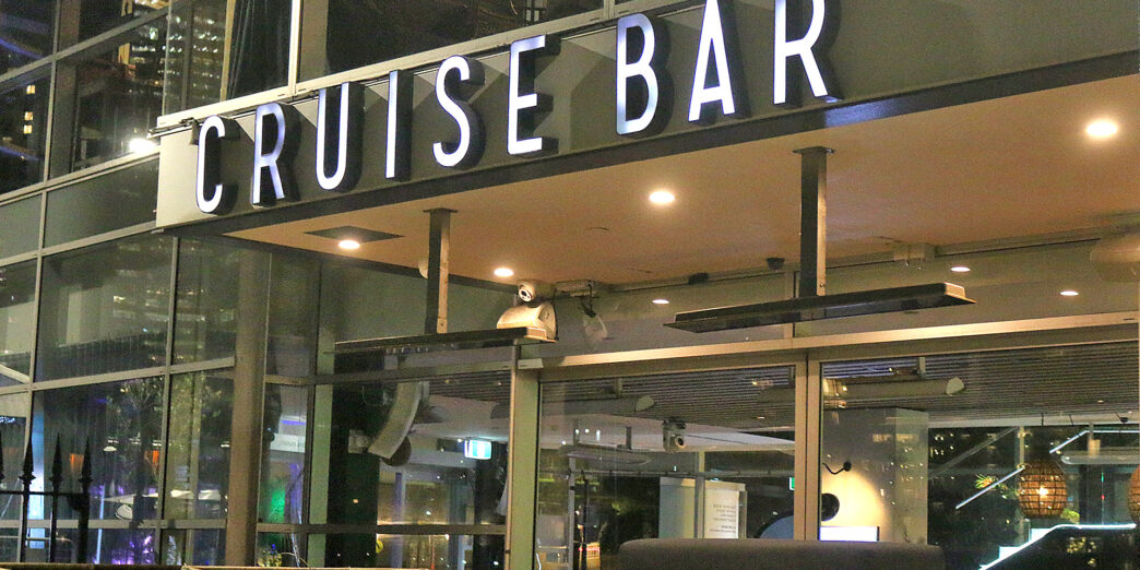 a cruise bar with a sign
