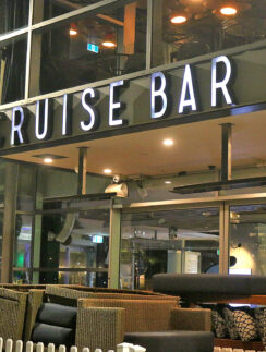 a cruise bar with a sign