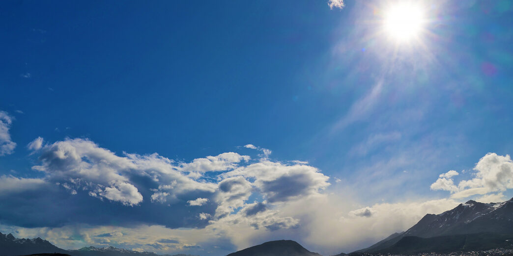 a body of water with mountains in the background