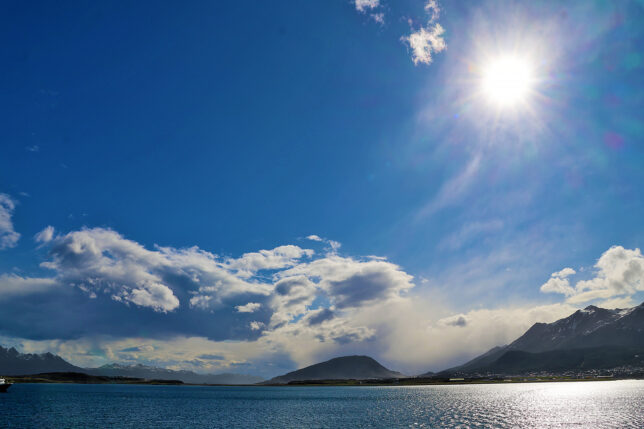 a body of water with mountains in the background