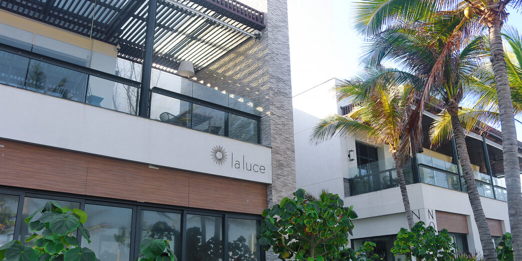 a building with palm trees and a roof