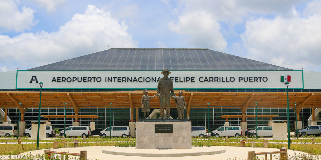 a statue of a man and a woman in front of a large building