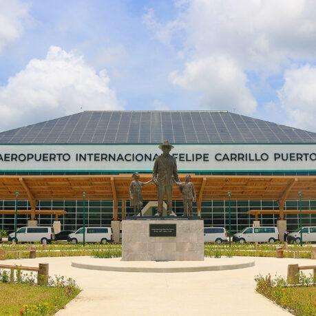 a statue of a man and a woman in front of a large building
