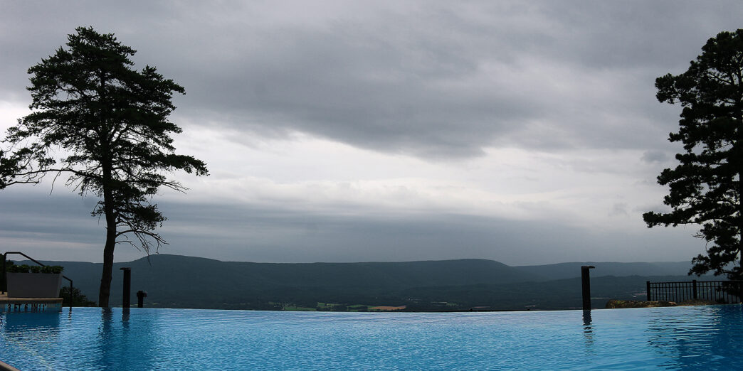 a pool with a view of the mountains