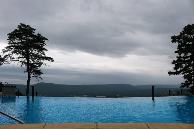 a pool with a view of the mountains