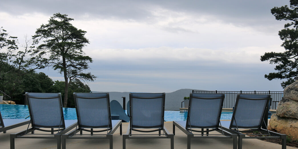 a group of chairs by a pool