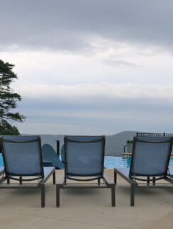 a group of chairs by a pool