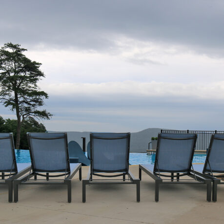 a group of chairs by a pool