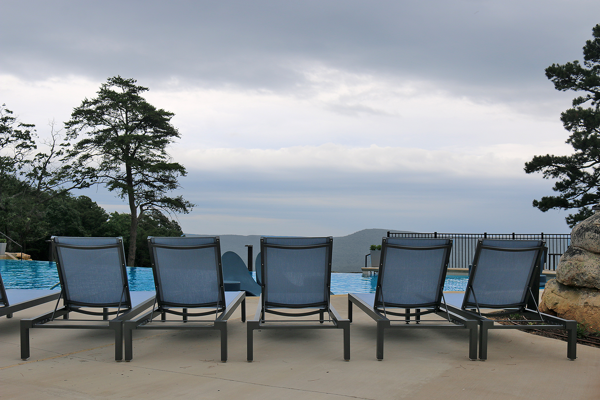 a group of chairs by a pool