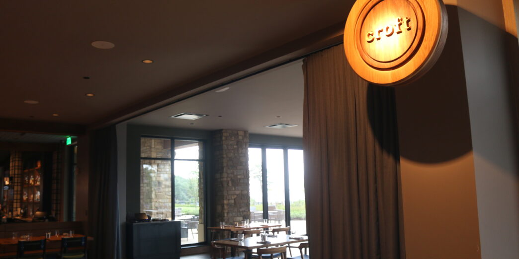 a room with a round sign and chairs