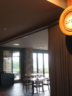 a room with a round sign and chairs