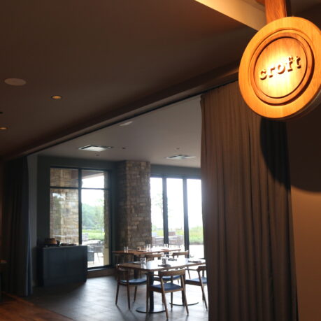 a room with a round sign and chairs