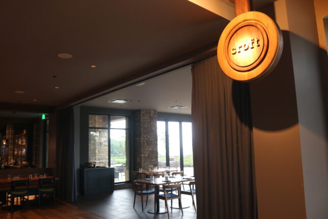 a room with a round sign and chairs