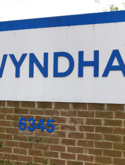 a sign on a brick wall