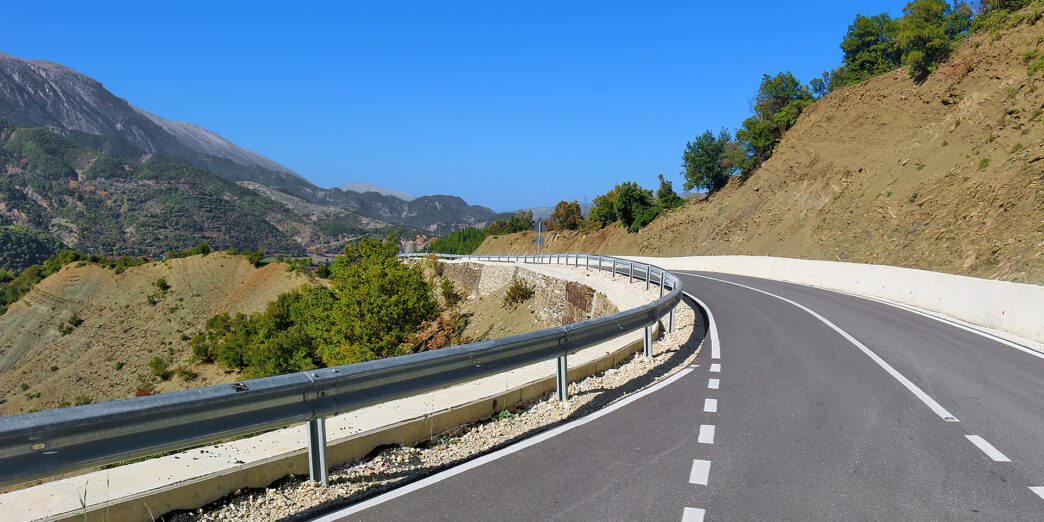 a road with a guard rail on the side