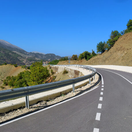 a road with a guard rail on the side