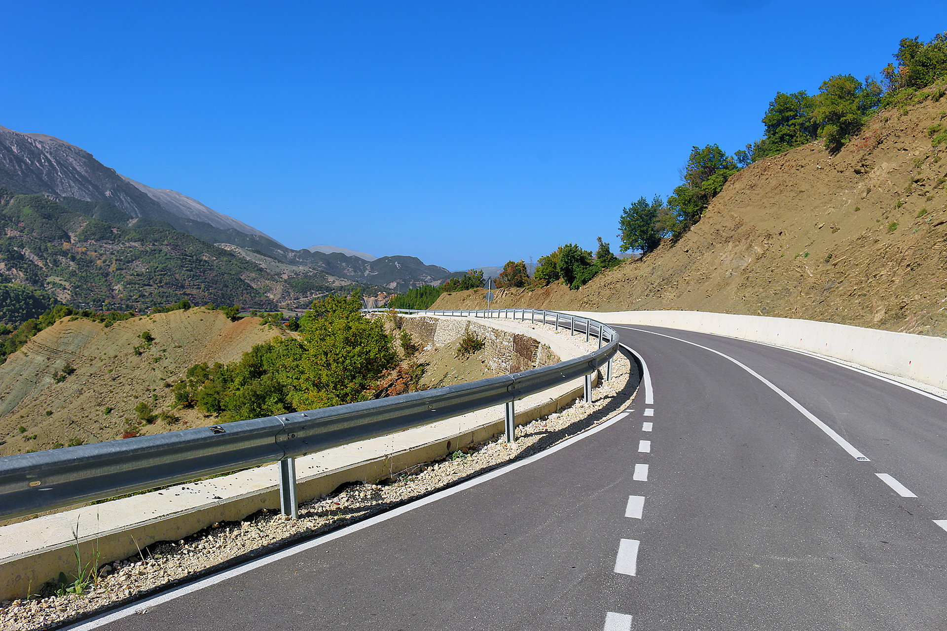 a road with a guard rail on the side