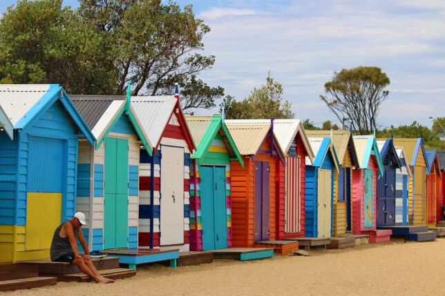 a row of colorful beach huts