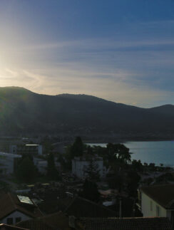 a sun shining over a city