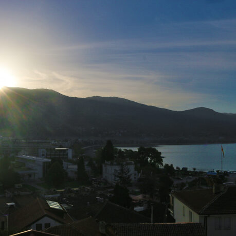 a sun shining over a city