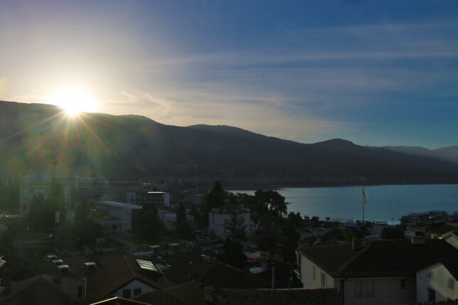 a sun shining over a city