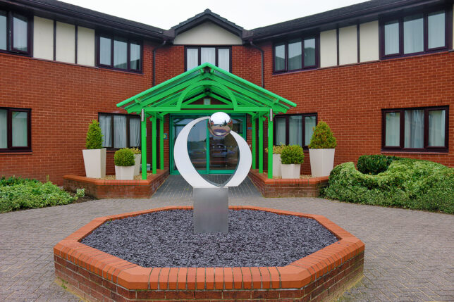 a sculpture in front of a building