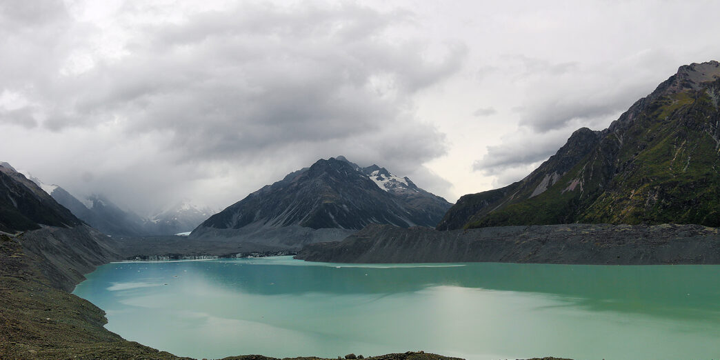 a body of water with mountains in the background