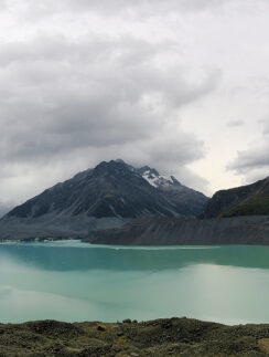 a body of water with mountains in the background