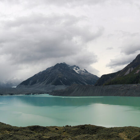 a body of water with mountains in the background