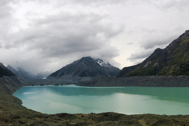 a body of water with mountains in the background