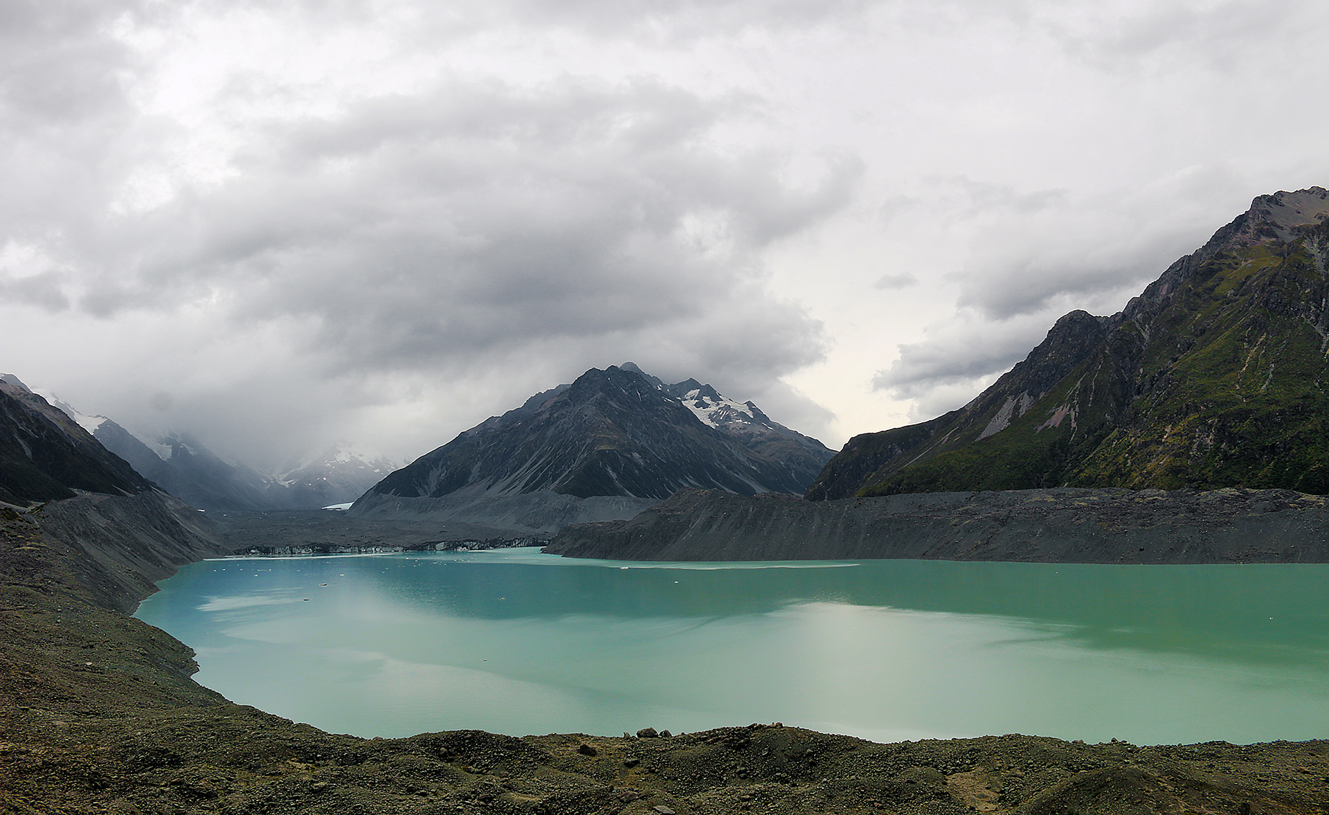 a body of water with mountains in the background