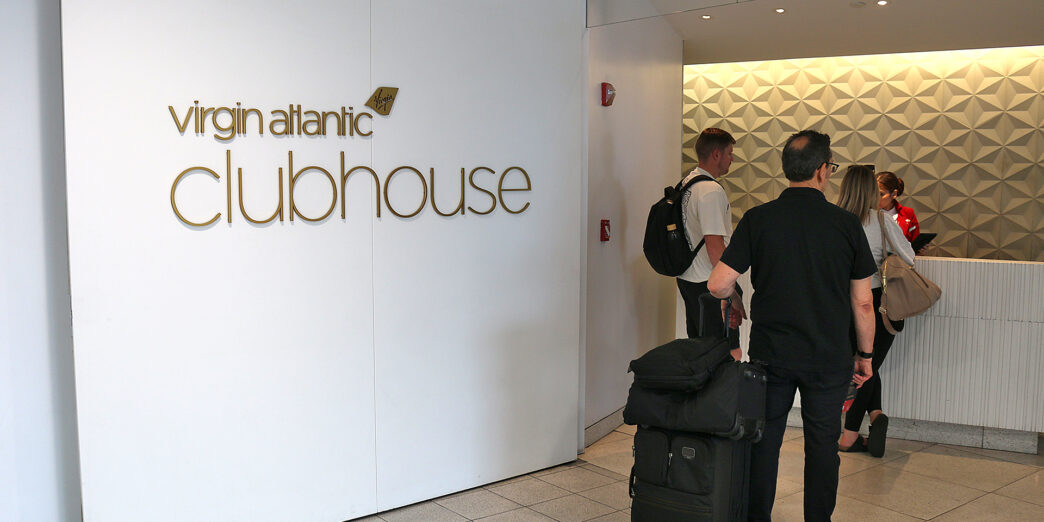 a group of people with luggage in a room