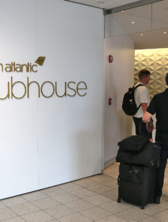 a group of people with luggage in a room