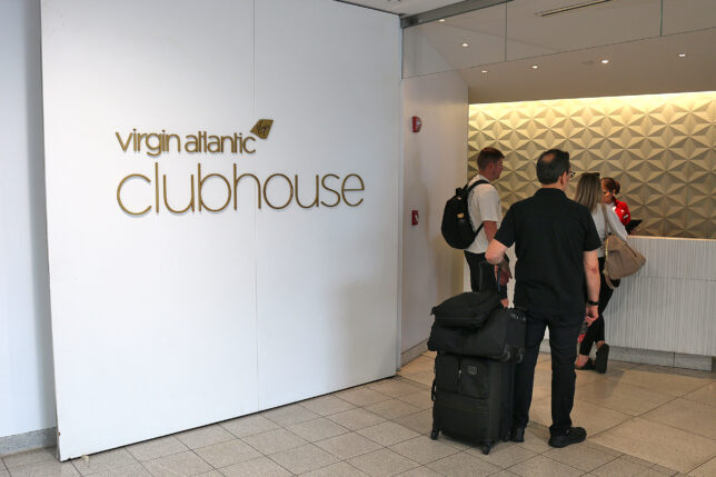 a group of people with luggage in a room