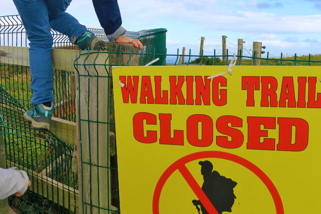 a person climbing a fence