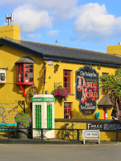 a yellow building with a sign on the front