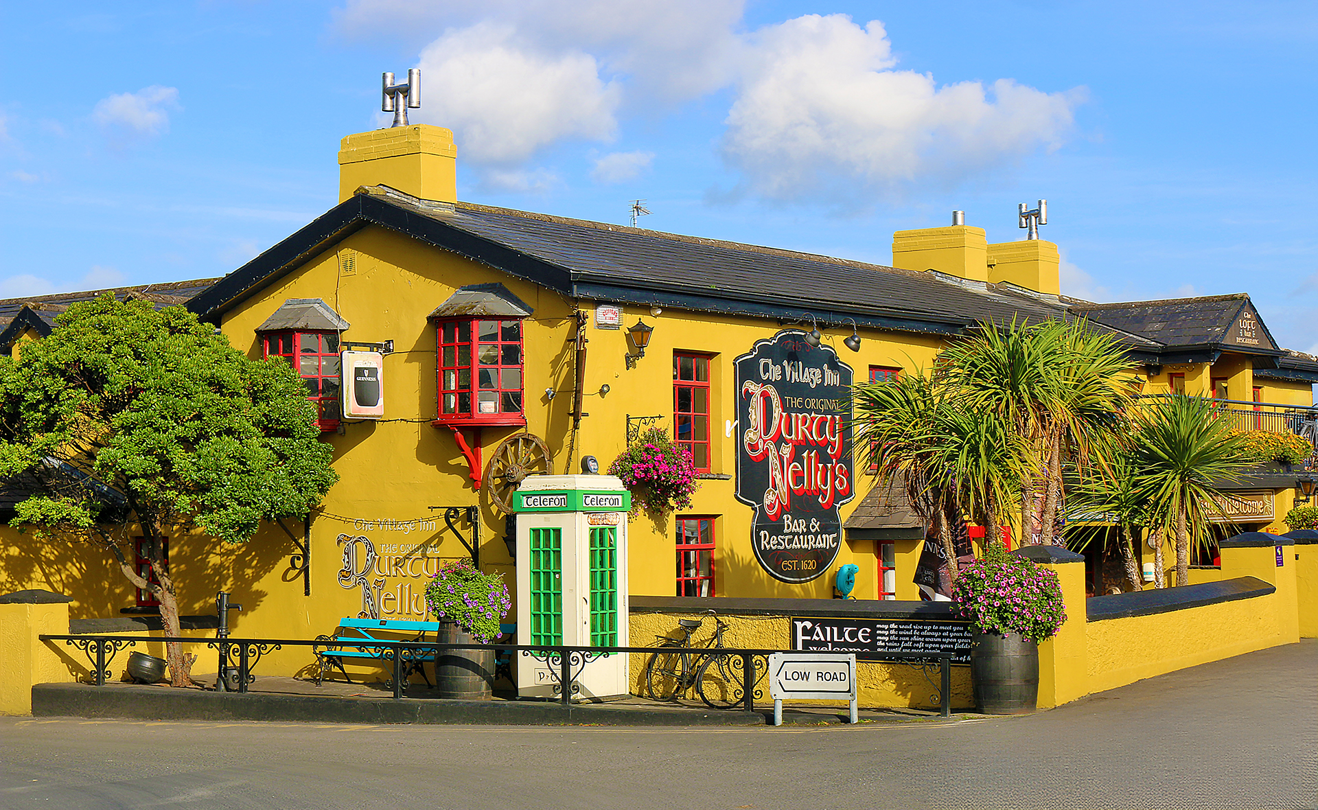 a yellow building with a sign on the front