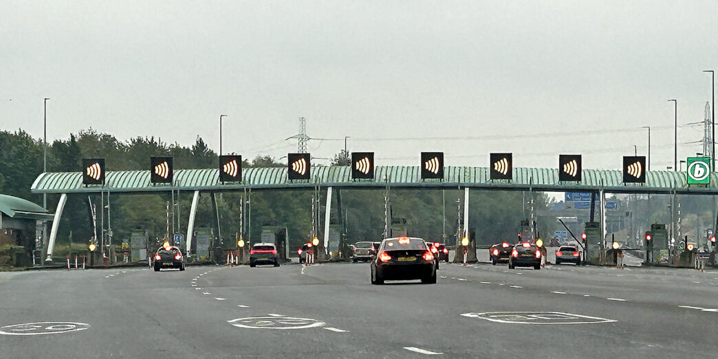 cars on a road with a bridge and a bridge