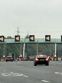 cars on a road with a bridge and a bridge